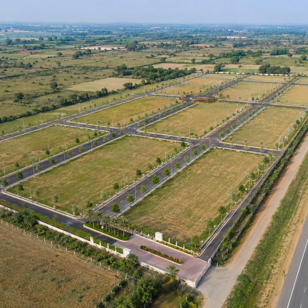 Godrej Plots Malur aerial view of a gated plotted layout beside the highway in the Malur corridor